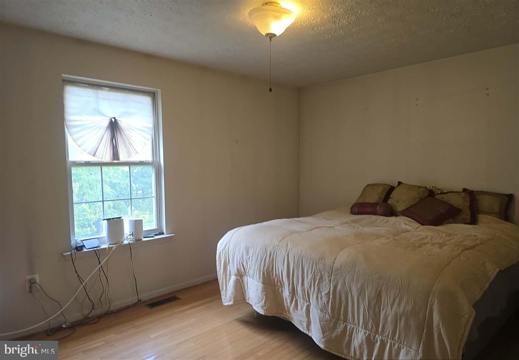 2448 Shellcove Court Waldorf, MD 20601 - Photo 7 of 18 a bed sitting in a bedroom next to a window