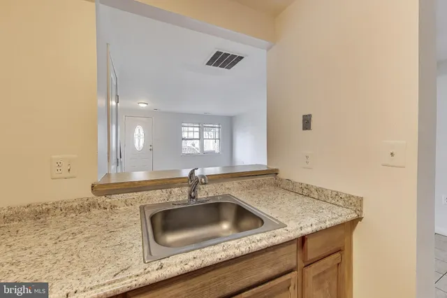 a kitchen with granite countertop a sink and a granite counter tops