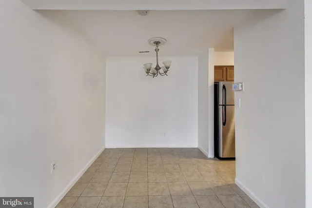 a view of a hallway with wooden floor and a cabinet