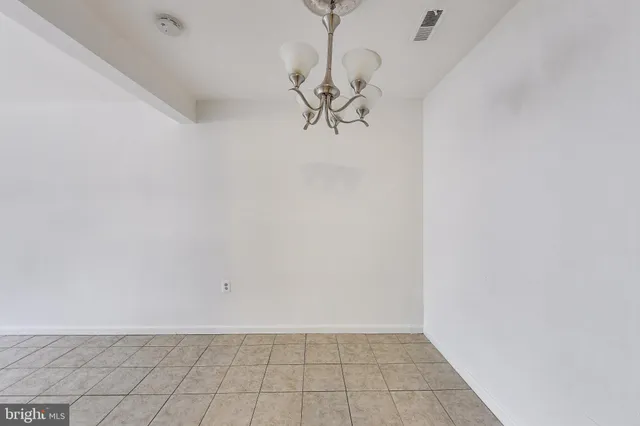a view of a room with wooden floor and glass door