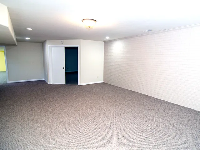 a front view of a house with a garden and deck