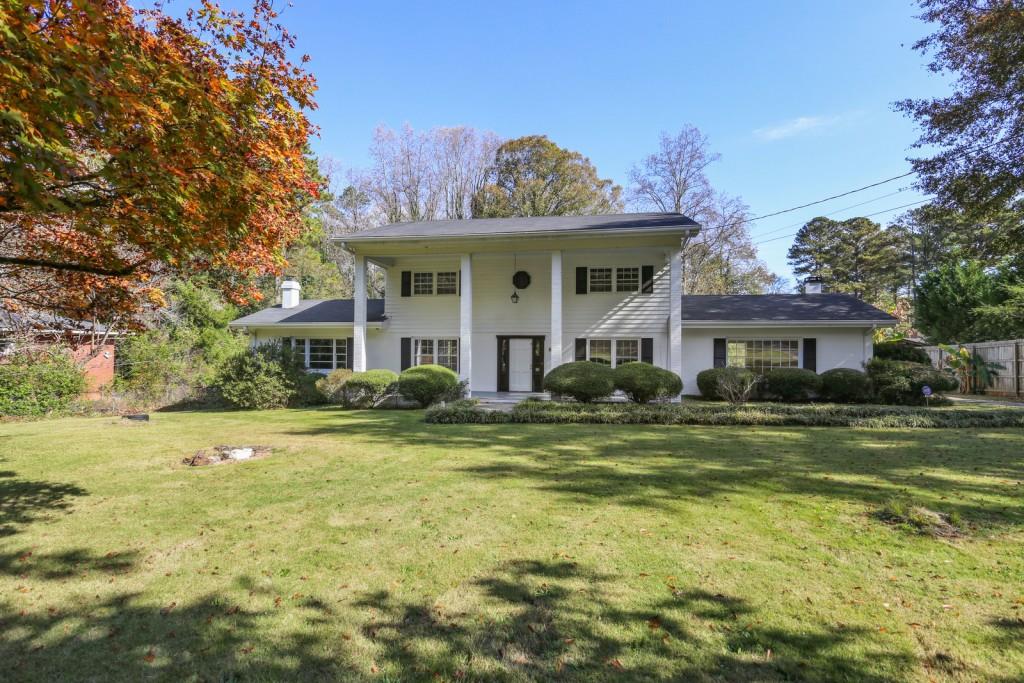 300 Plantation Road Southwest Smyrna, GA 30082 - Photo 1 of 1 a view of a big house with a big yard and potted plants and large trees