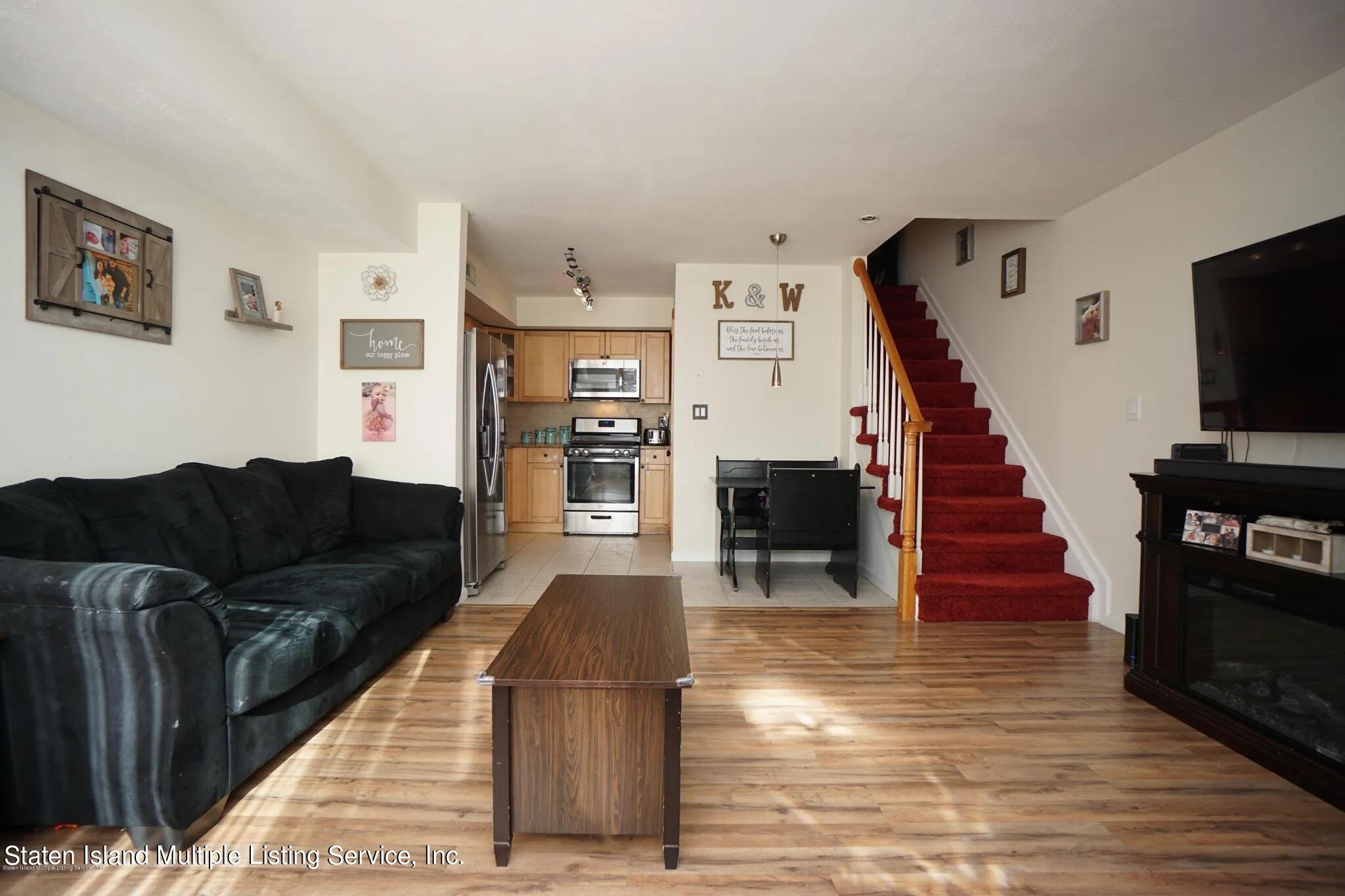 54 Selvin Loop Staten Island, NY 10303 - Photo 3 of 9 a living room with furniture and a flat screen tv
