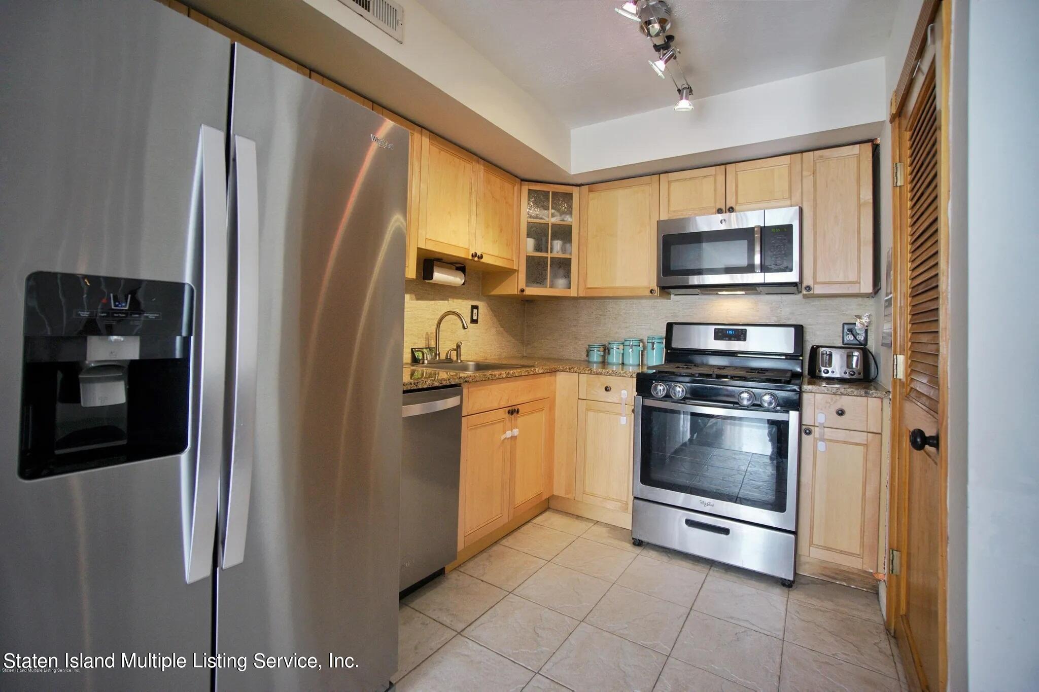 54 Selvin Loop Staten Island, NY 10303 - Photo 6 of 9 a kitchen with stainless steel appliances granite countertop a refrigerator stove and sink
