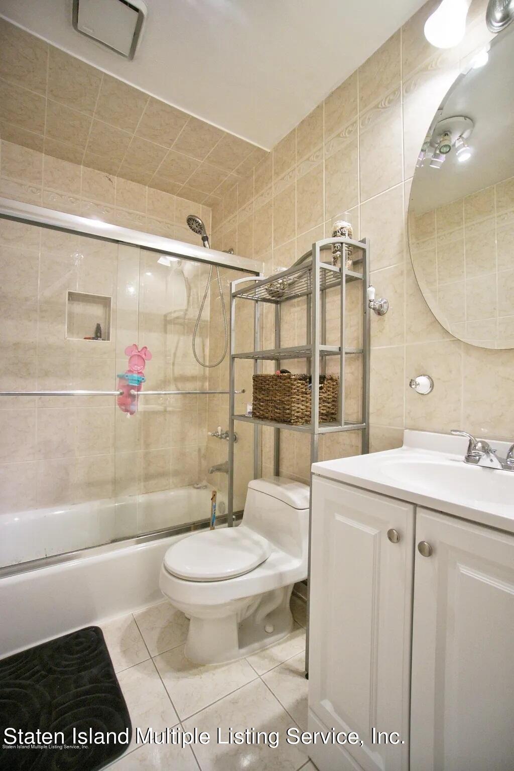 54 Selvin Loop Staten Island, NY 10303 - Photo 9 of 9 a bathroom with a sink toilet and shower