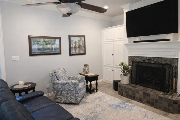 a living room with furniture a flat screen tv and a fireplace