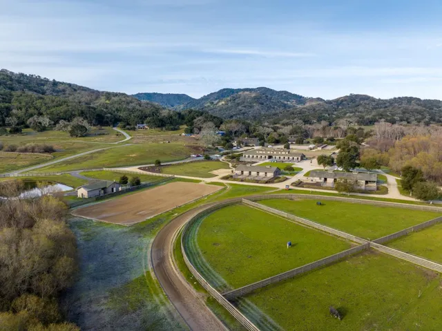 an aerial view of a house with a lake view