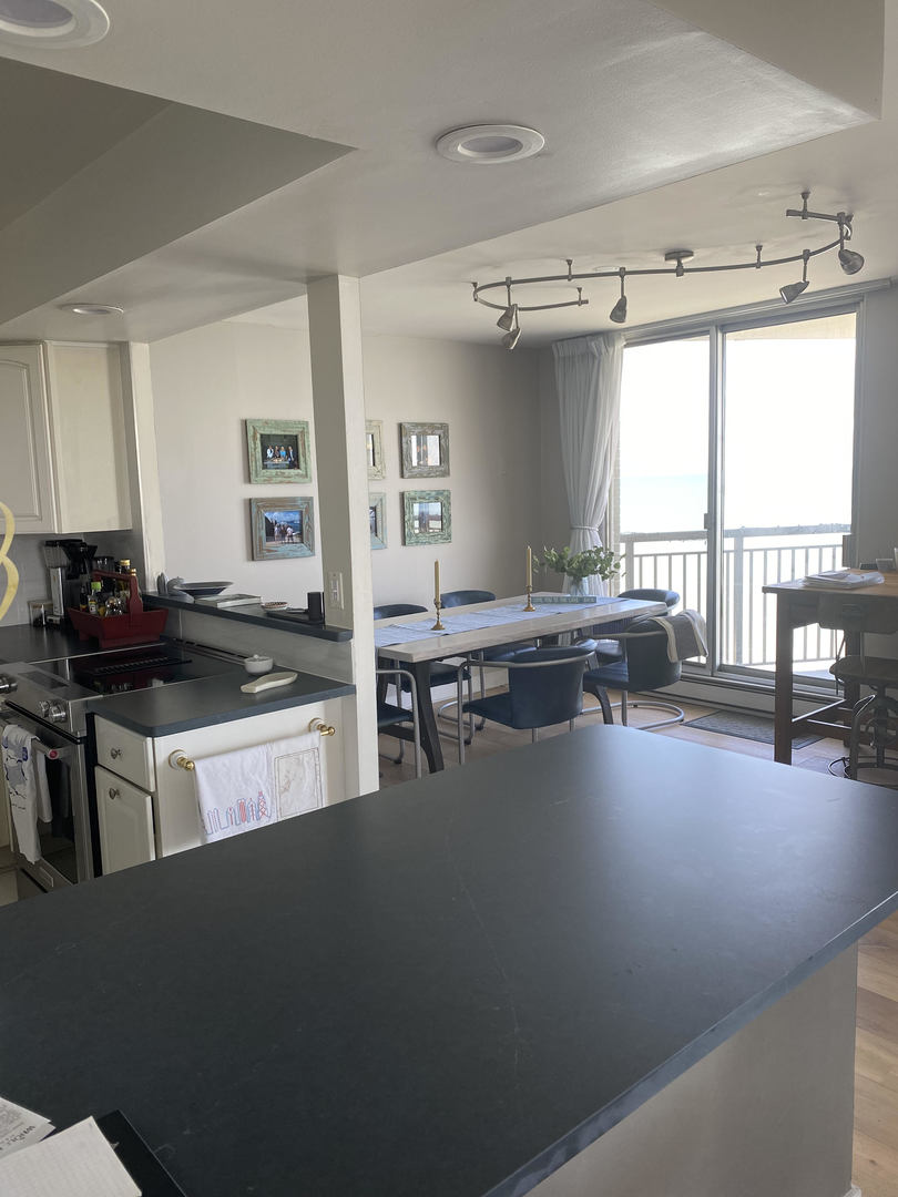6007 North Sheridan Road, Unit 31A Chicago, IL 60660 - Photo 12 of 19 a kitchen with a counter top space a sink a stove and a window
