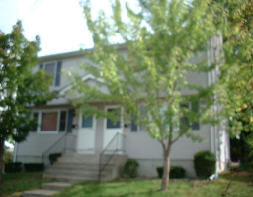 57-63 Lyons Street Springfield, MA 01151 - Photo 2 of 2 a view of house with yard and sitting area