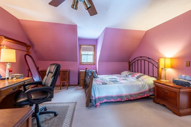 a bedroom with a bed a desk and chair