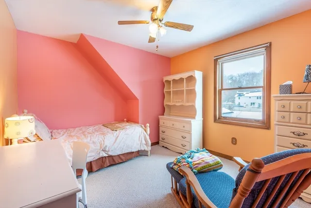 a bedroom with two beds and a window