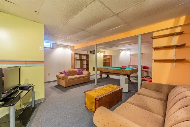 a living room with furniture a rug and a window