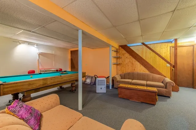 a backyard of a house with couches table and chairs