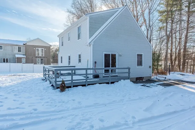 a view of a house with a yard covered in snow