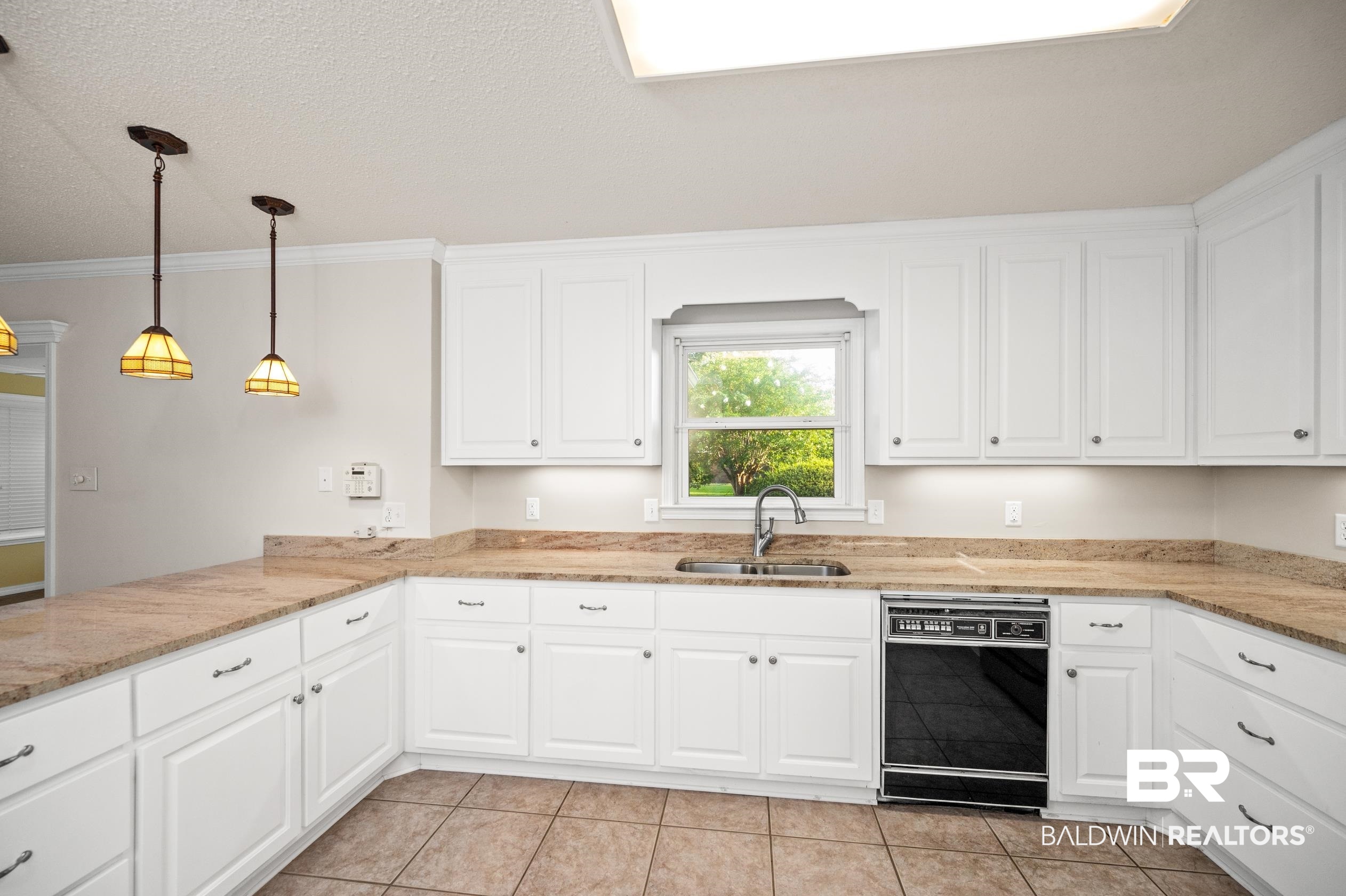 303 West Palm Avenue Foley, AL 36535 - Photo 6 of 32 Kitchen featuring sink, hanging light fixtures, light tile patterned flooring, dishwasher, and ornamental molding