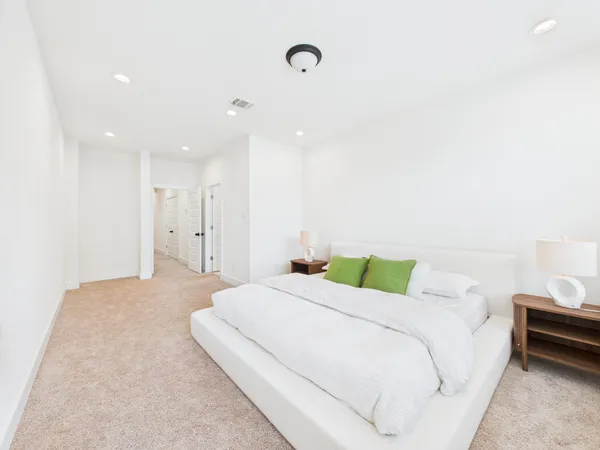 a bedroom with a bed and a night stand