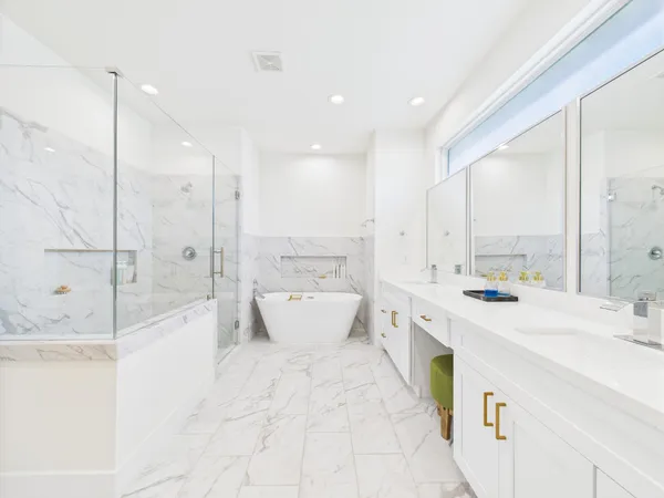 a large white bathroom with a large tub sink shower and view