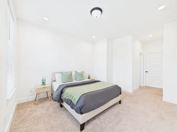 a bedroom with a bed and a night stand