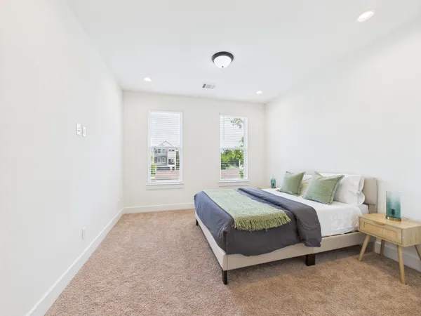 a spacious bedroom with a bed and a couch