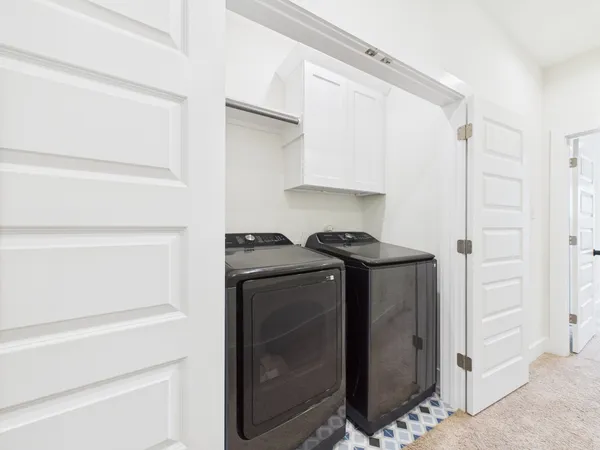 a view of storage and utility room with washer and dryer