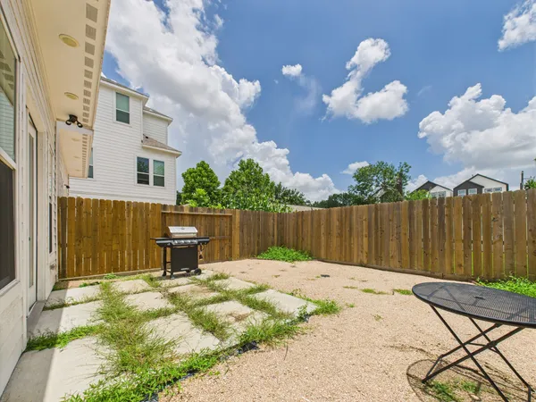 a backyard of a house with table and chairs