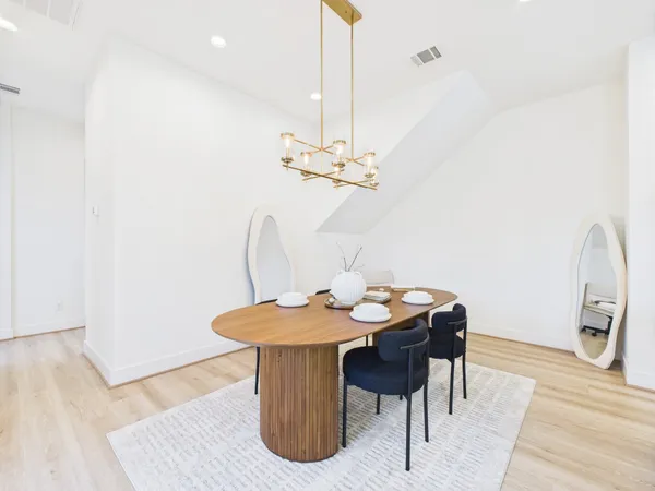 a dining room with furniture and wooden floor