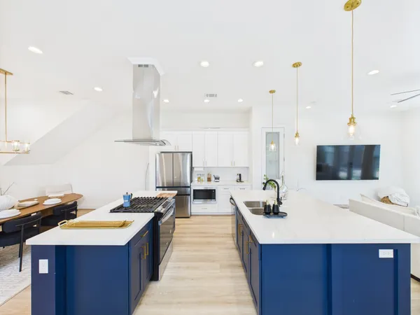 a large kitchen with kitchen island a sink counter space and living room view