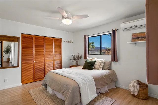 a bedroom with a large bed and a window