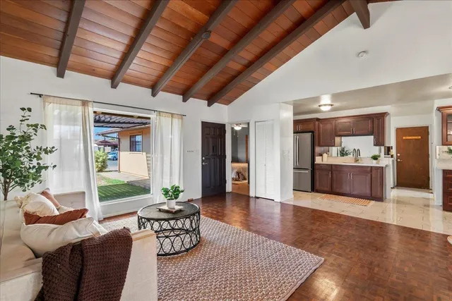 a view of a livingroom with furniture and a ceiling fan