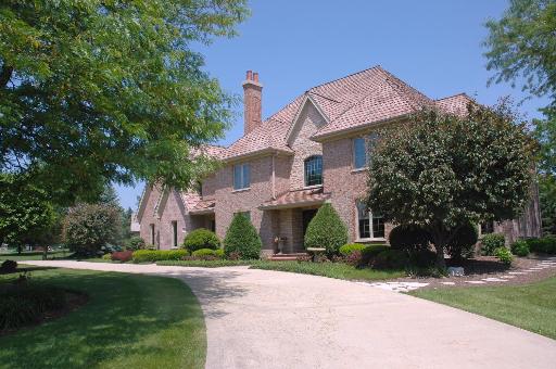 a front view of a house with a yard and a garage