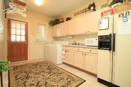 36W466 Lancaster Road St. Charles, IL 60175 - Photo 14 of 16 a kitchen with a refrigerator and white cabinets