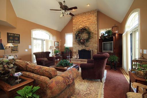 36W466 Lancaster Road St. Charles, IL 60175 - Photo 4 of 16 a living room with furniture a large window and a fireplace