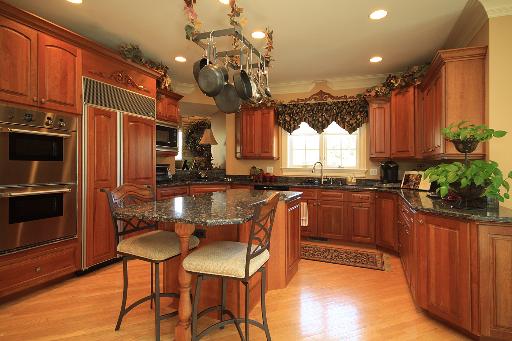 36W466 Lancaster Road St. Charles, IL 60175 - Photo 5 of 16 a kitchen with granite countertop wooden cabinets and stainless steel appliances