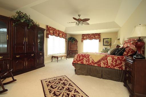 36W466 Lancaster Road St. Charles, IL 60175 - Photo 7 of 16 a bed room with a bed and a chandelier