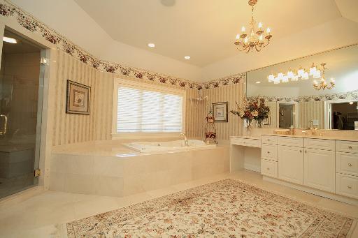 36W466 Lancaster Road St. Charles, IL 60175 - Photo 8 of 16 a bathroom with a tub sink and mirror