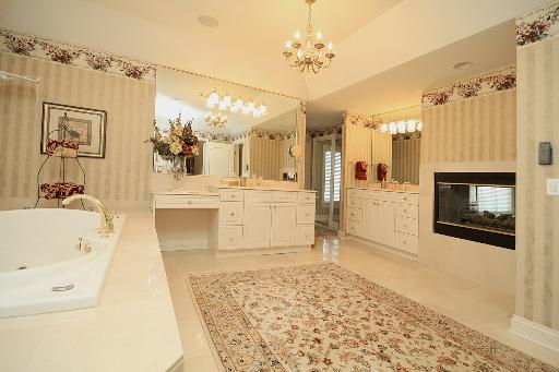 36W466 Lancaster Road St. Charles, IL 60175 - Photo 9 of 16 a spacious bathroom with a tub a sink and mirror
