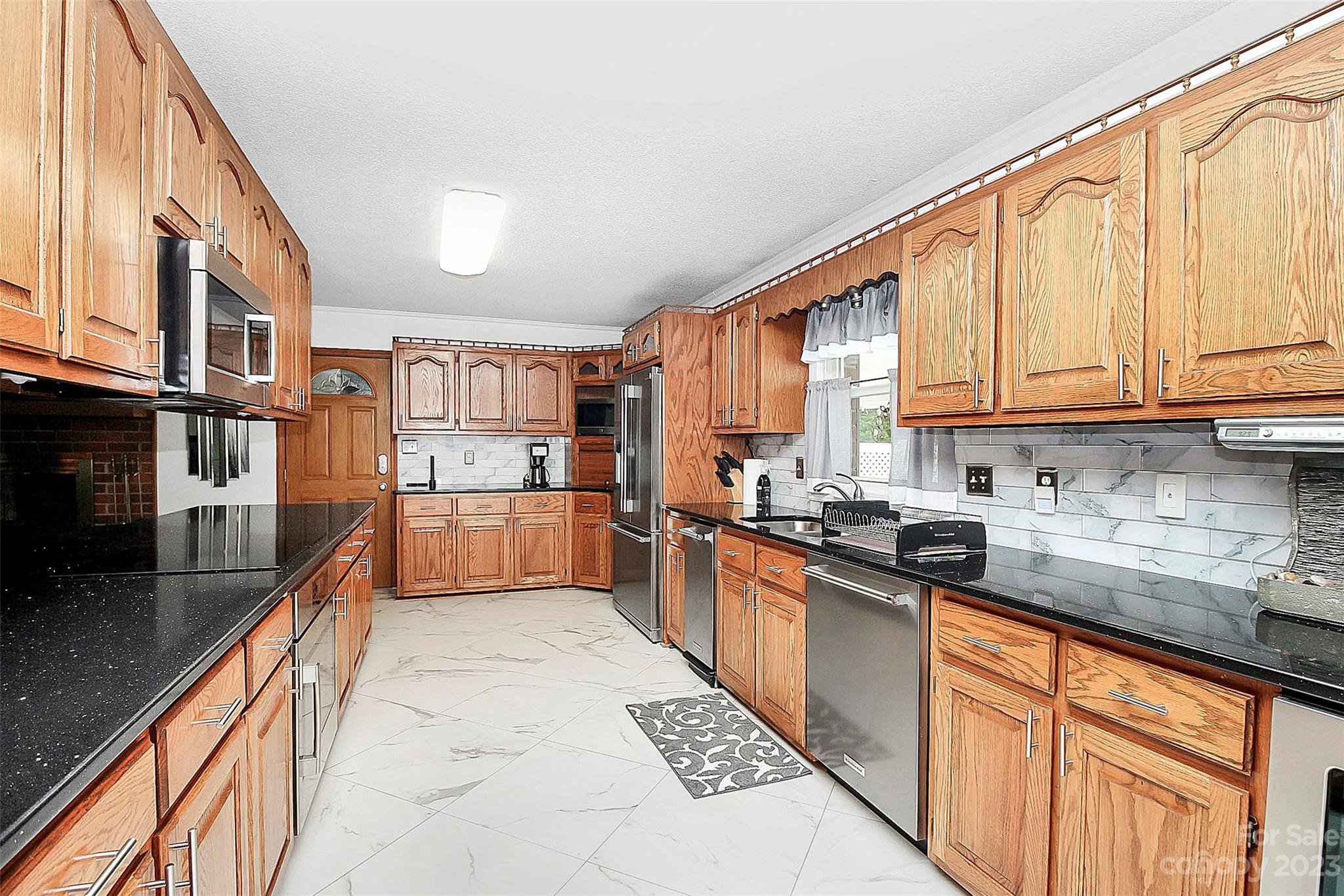 870 Bridle Path Fort Mill, SC 29708 - Photo 14 of 34 a large kitchen with stainless steel appliances granite countertop a stove a sink and a refrigerator