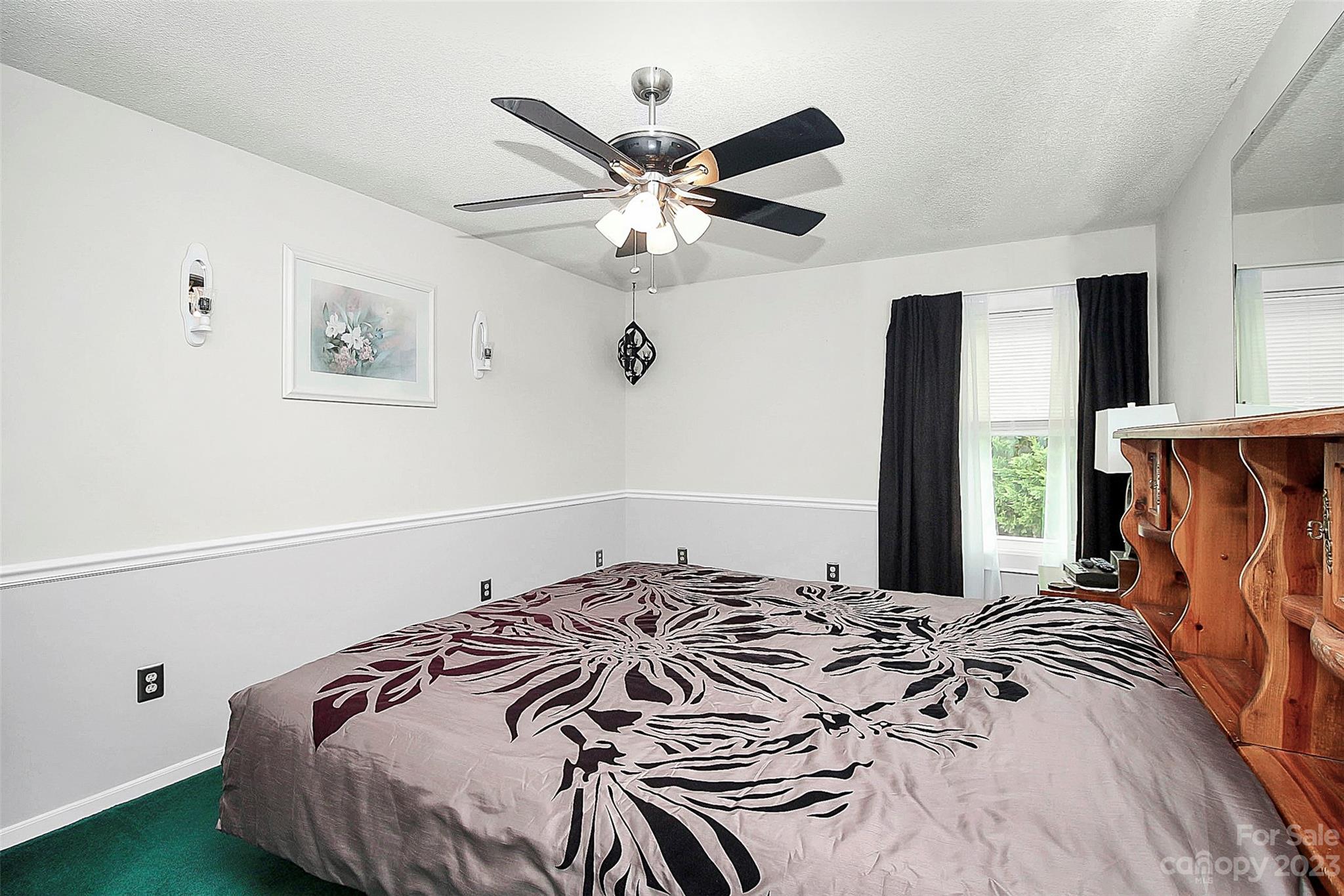 870 Bridle Path Fort Mill, SC 29708 - Photo 33 of 34 a bedroom with a bed and a chandelier