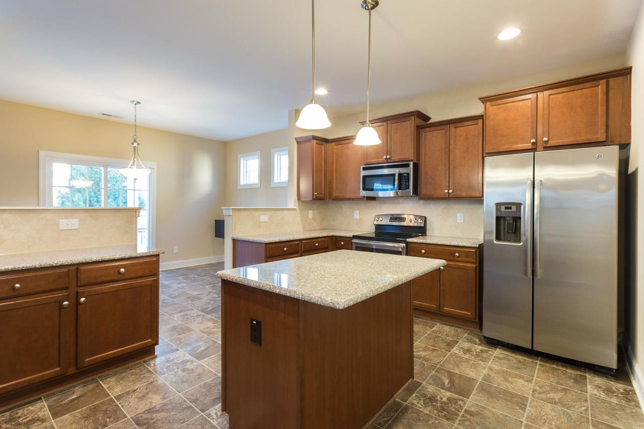 7651 Birchmoor Way Raleigh, NC 27616 - Photo 7 of 23 Flat Panel Custom Cabs, Tile Backsplash, Kitchen Island, Stainless Steel Appliances Throughout. CHEF'S KITCHEN