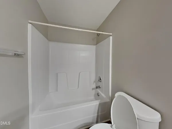 a view of a house with backyard and wooden fence