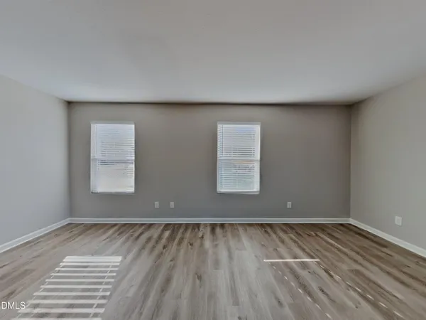 a view of a room with wooden floor and window