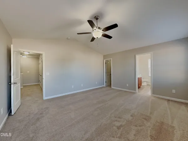 an empty room with closet and windows