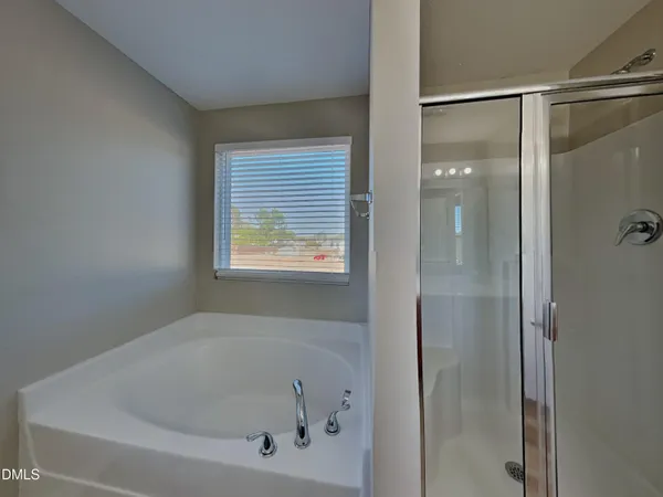 a bathroom with a bathtub and a shower