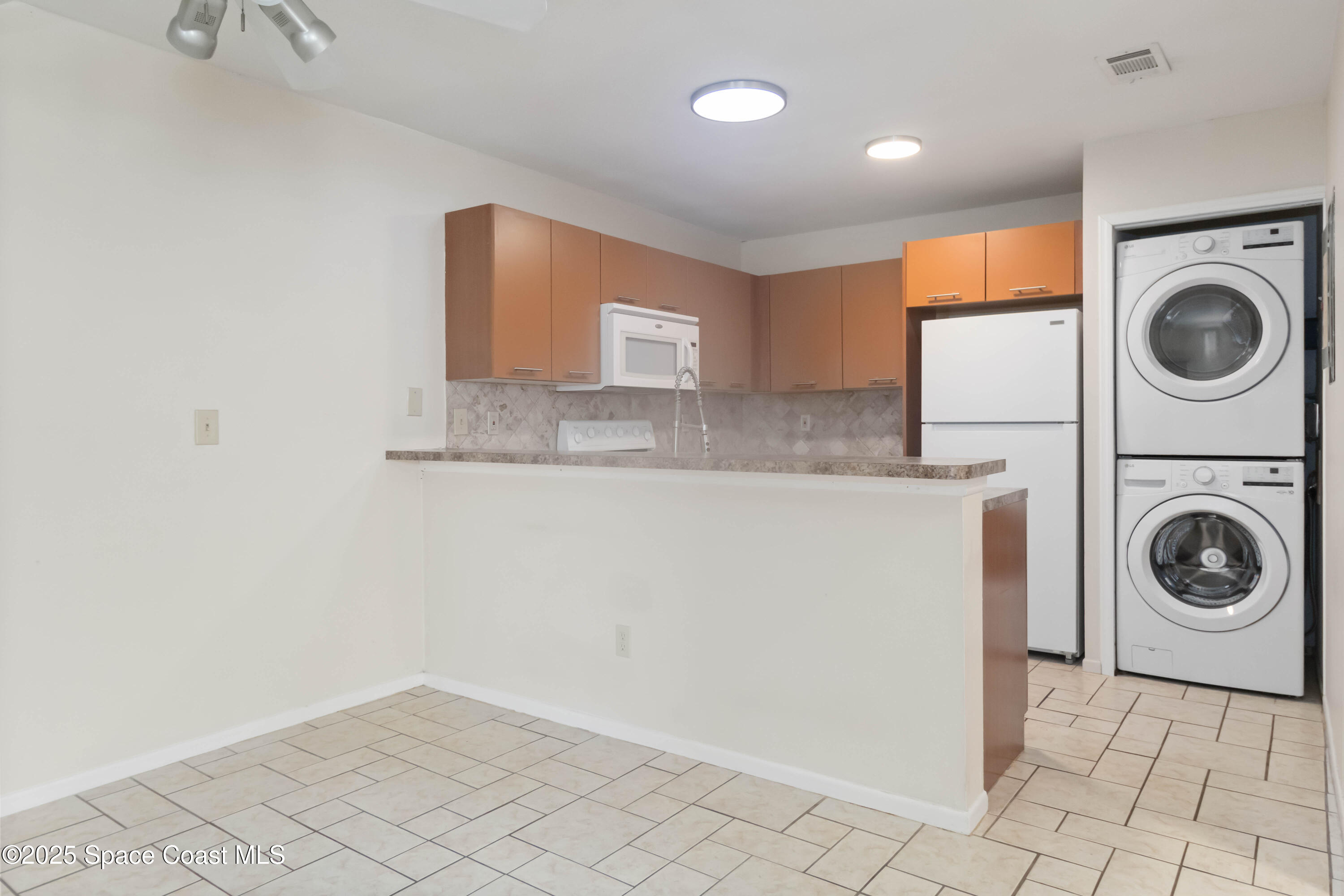 1480 Sheafe Avenue Northeast, Unit 103 Palm Bay, FL 32905 - Photo 16 of 31 a utility room with sink dryer and washer