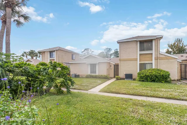 a view of a house with a backyard