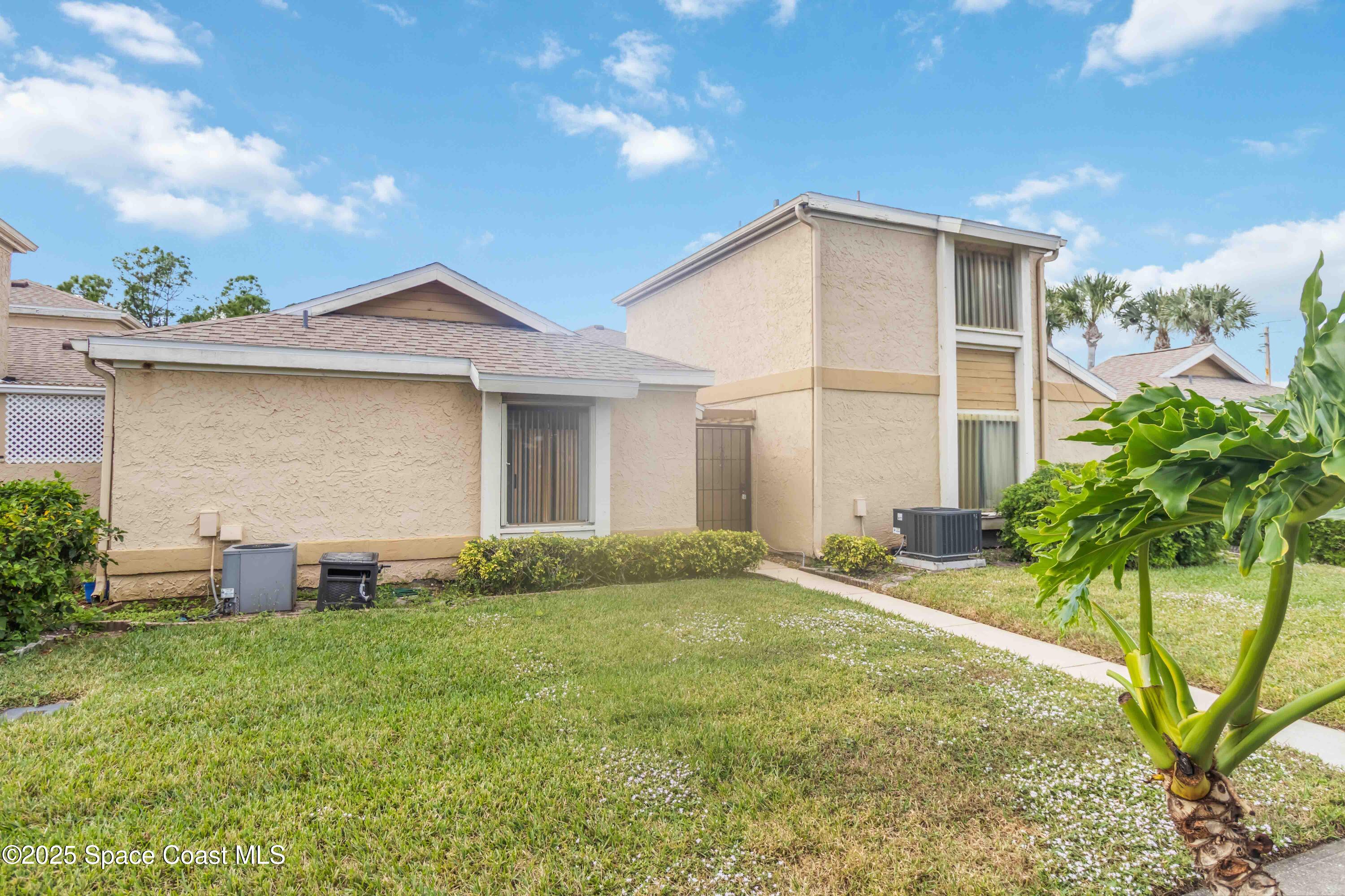 1480 Sheafe Avenue Northeast, Unit 103 Palm Bay, FL 32905 - Photo 21 of 31 a front view of a house with garden