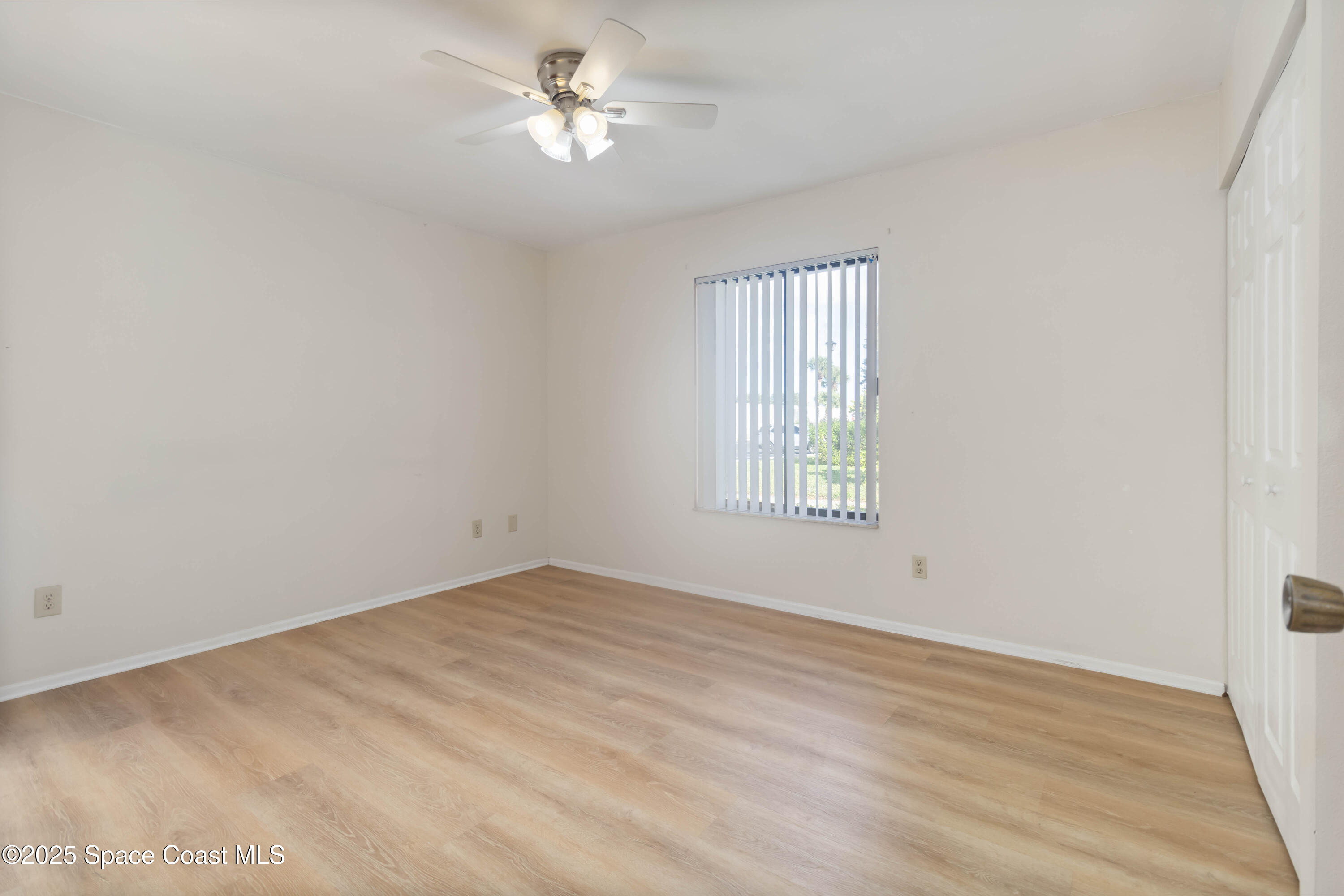 1480 Sheafe Avenue Northeast, Unit 103 Palm Bay, FL 32905 - Photo 24 of 31 a view of empty room with wooden floor and fan
