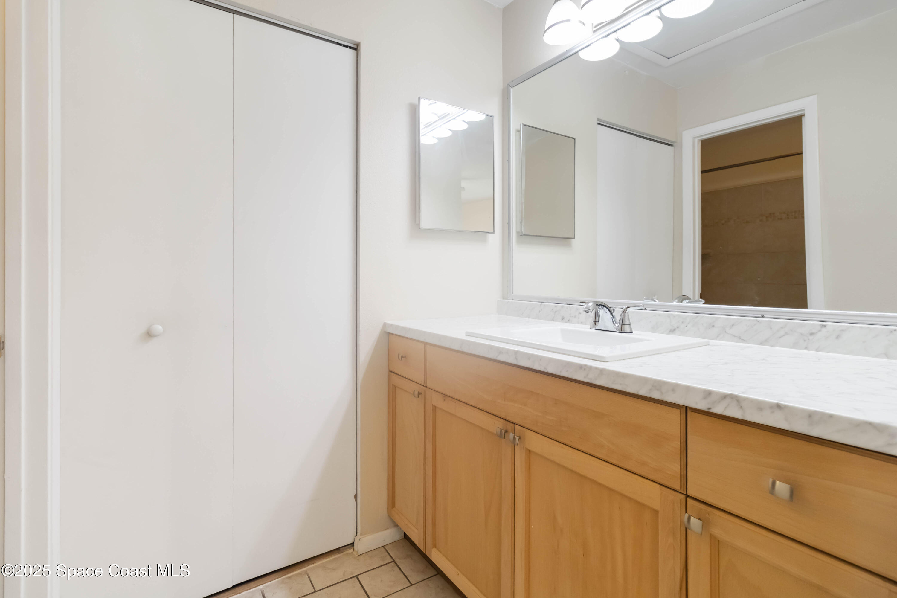 1480 Sheafe Avenue Northeast, Unit 103 Palm Bay, FL 32905 - Photo 26 of 31 a bathroom with a sink and a mirror