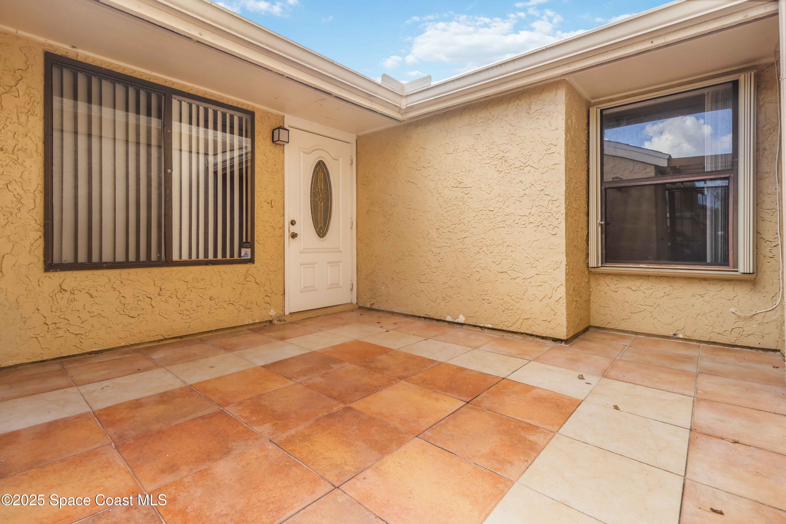 1480 Sheafe Avenue Northeast, Unit 103 Palm Bay, FL 32905 - Photo 5 of 31 a view of a car garage door