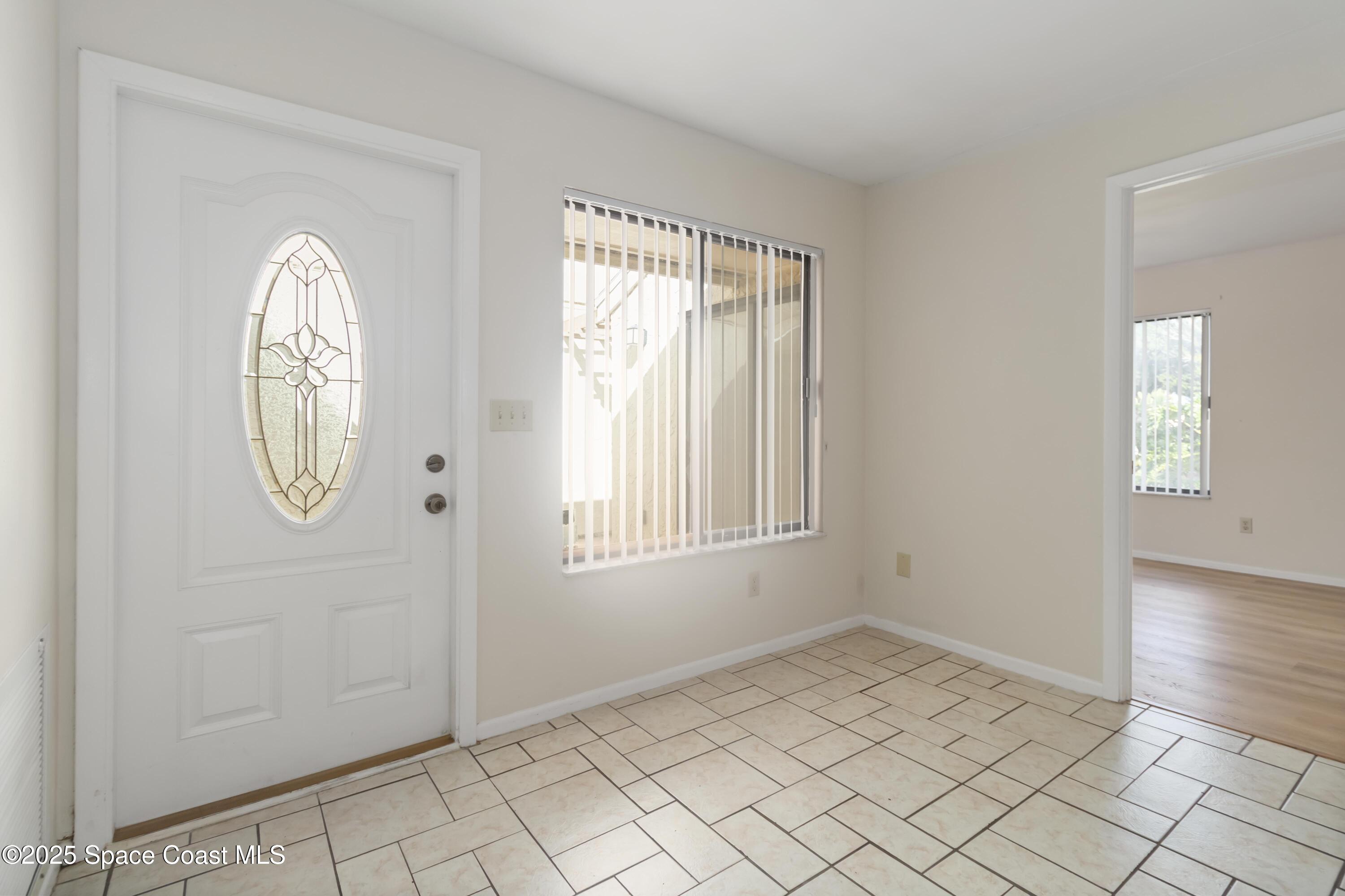 1480 Sheafe Avenue Northeast, Unit 103 Palm Bay, FL 32905 - Photo 7 of 31 an empty room with windows